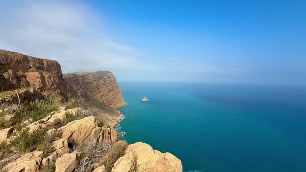 Experience a breathtaking panorama showcasing clear turquoise waters and rugged cliffs beneath a brilliant blue sky
