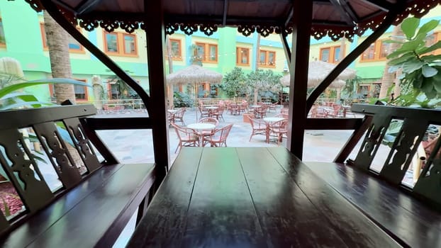 A charming gazebo offers a serene atmosphere and beautiful views of the vibrant outdoor dining area