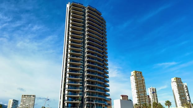 Elegant highrises majestically stand against a stunningly beautiful sky in a vibrant and bustling urban setting