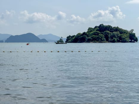Secluded beach top with tropical scenery and a hidden paradise, showcasing pristine sandy beaches, palm trees and small islands on the stunning ocean waters. Exotic Thai panorama.
