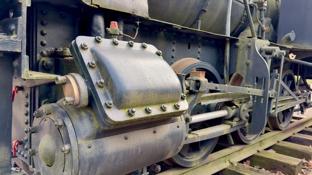 This is a closeup detailed view of a vintage steam locomotives intricate engine components and machinery systems