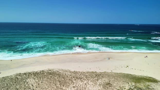 A beautifully breathtaking beach scene featuring gentle waves and soft, inviting sand, ideal for relaxation and escape