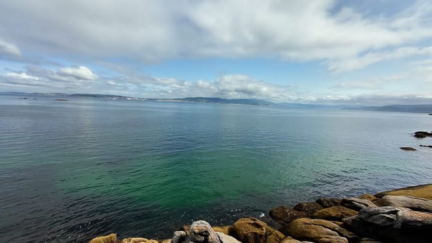 Calm waves and a stone shore of a beautiful bay of the Atlantic Ocean. High quality 4k footage