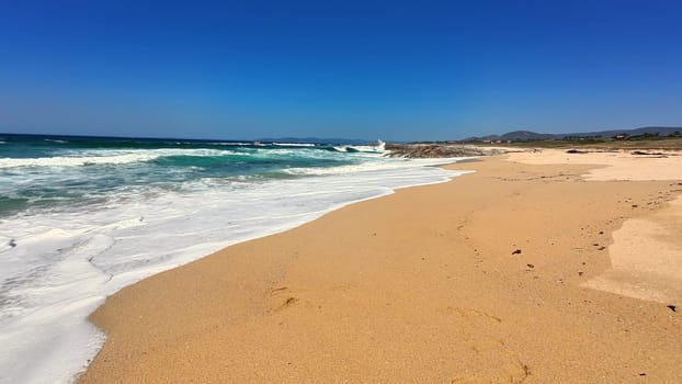 A breathtaking beach scene showcasing golden sands and vibrant turquoise waves beneath a clear blue sky