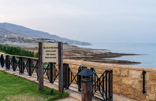 Sign by the Dead Sea in Jordan stating the lowest point on earth at 420m below sea level