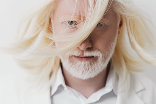 This striking portrait features a mature man with long white hair and a beard, set against a clean, light background His expression exudes strength and individuality, accentuated by the flowing hair
