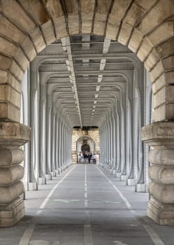 France, Paris - May 03, 2025 - Horizontal perspective view of Stone columns and Steel beams of Steel bridge, Architectural structure of the famous Pont de Bir Hakeim bridge in Paris. use it as your Wallpaper, Poster and Copy space, Selective focus.