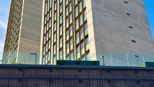 A stunning and impressive highrise architecture showcasing sleek design against a clear blue sky above