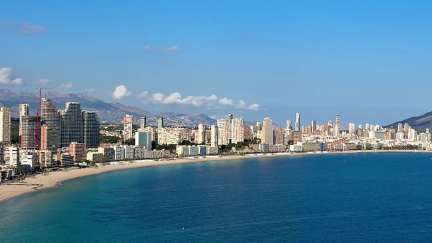 The stunning coastal skyline of Benidorm showcases its beautiful sandy beaches and clear, inviting blue waters