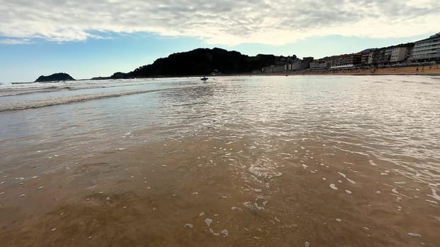 Imagine a tranquil beach view with gentle waves reflecting the beautiful sky and scenic coastal hills nearby