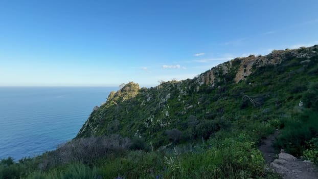 A breathtakingly beautiful coastal landscape featuring majestic cliffs, vibrant greenery, and serene ocean tranquility