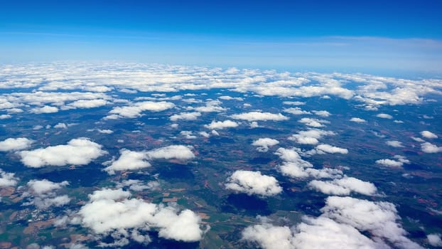 Stunning aerial footage beautifully showcasing vivid clouds and vibrant lush green fields captured from above