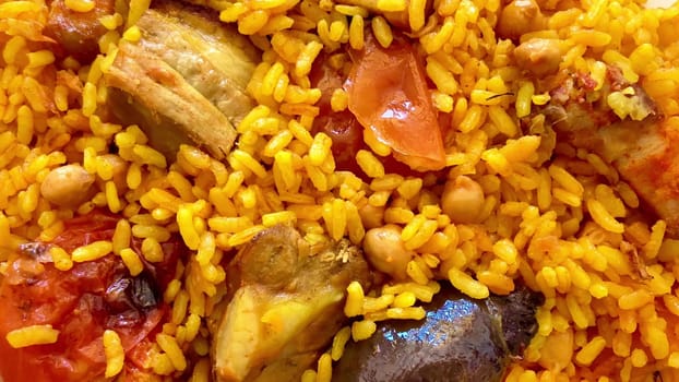 A vibrant plate of Jollof rice, garnished with meat and fresh vegetables, perfect for any special occasion