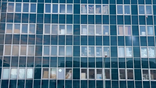This contemporary office building boasts a striking glass facade that perfectly captures stunning reflections