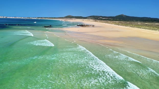 Experience the beauty of a tranquil beach with clear waters and golden sands, perfect for relaxation.