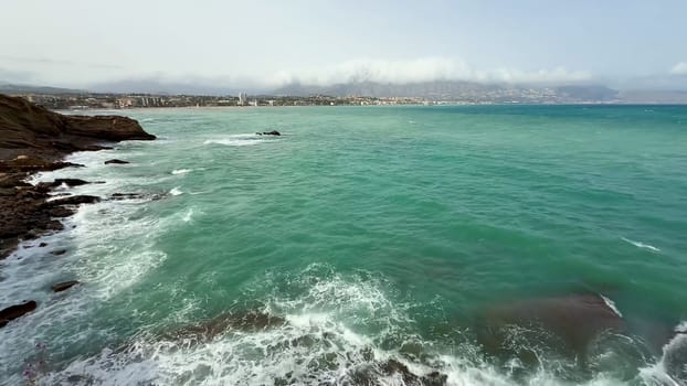 A breathtaking view of the calm sea and rocky coast, showcasing the beauty of nature's serene landscape.