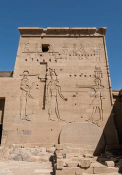 Detail of the bas-relief carving of the Isis and Horus facing Pharoah in the reconstructed Philae Temple in Aswan Harbor in Egypt