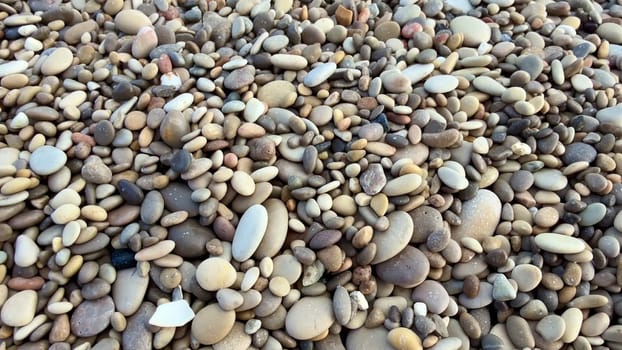 A beautifully tranquil beach scene featuring smooth pebbles and gently rolling ocean waves in a peaceful setting