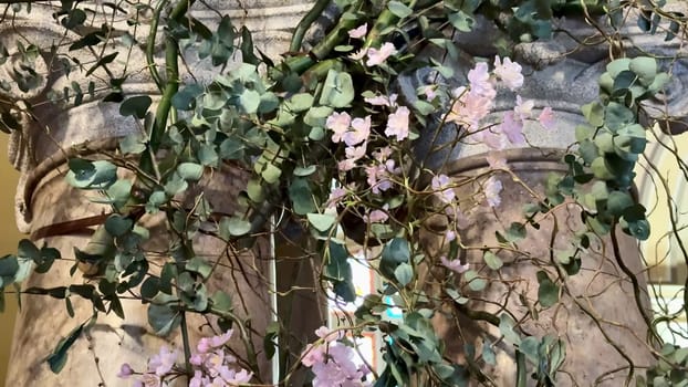 A stunning display of orchids and lush greenery beautifully entwined, making it perfect for elegant decoration