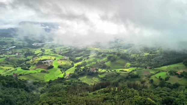 A stunning aerial view showcases vibrant greenery and cloudy skies, perfect for exploring and appreciating nature