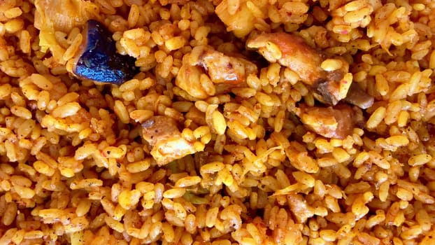 A vibrant and colorful plate of jollof rice beautifully garnished with succulent chicken, rich in flavor