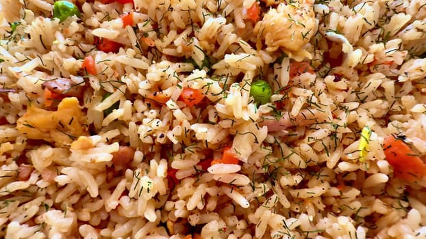 A vibrant and colorful plate of fried rice, filled with fresh vegetables and aromatic herbs to truly delight the senses