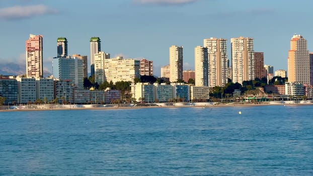 A mesmerizing city skyline view stretches over tranquil waters, beautifully capturing urban life by the seaside