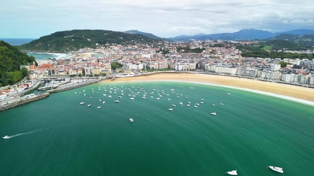 Aerial view of a stunning coastal city with a vibrant beach and boats scattered across the landscape
