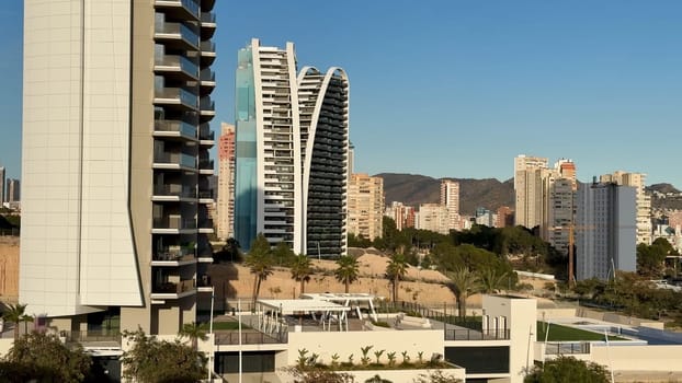 The view of contemporary and stylish buildings truly shines against a brilliant clear sky in this vibrant cityscape