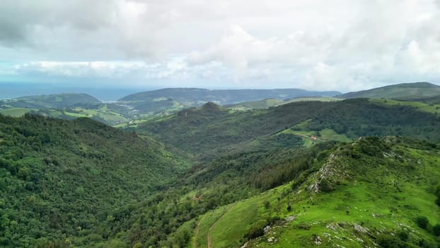 The stunning view captures the lush green hills and expansive valleys beneath a beautifully dramatic sky