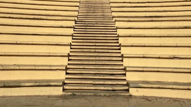 The amphitheater steps, surrounded by lush greenery, create a perfect space for events and gatherings