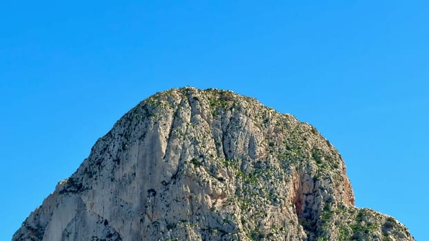A breathtaking rocky peak majestically showcases the natural beauty that stands against a vibrant blue sky