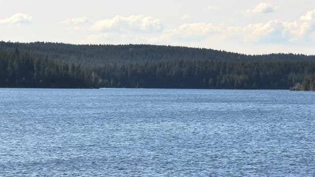 A serene lake reflects vibrant skies and lush forests, creating a peaceful setting for relaxation and exploration