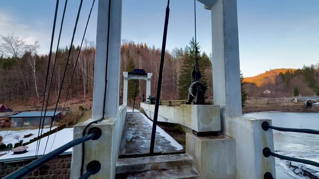 A beautiful and peaceful suspension bridge gracefully nestled in nature at dusk, ideal for tranquil landscapes