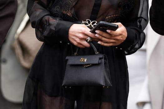 Paris, France - February, 29, 2024: woman wears Hermes Kelly bag, fashion blogger outfit details, street style.