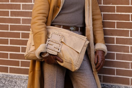 Milan, Italy - January, 13, 2024: man wears Fendi Baguette bag, street style details, fashion outfit detail