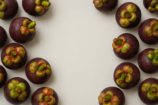 AI generated vibrant image of purple mangosteens arranged in circular formation with glistening water droplets, showcasing their royal purple rinds and fresh calyx against clean white background