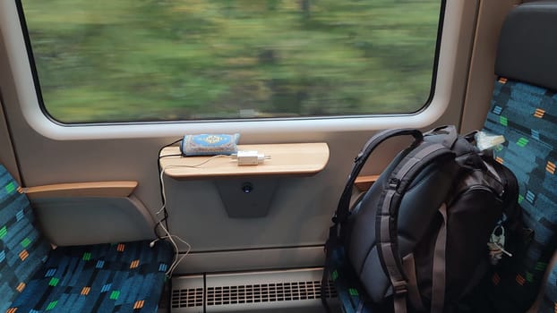 Train window backpack table objects furniture shotlisttravel travel tourism summer transport sites sitting waiting place destination objects . High quality photo