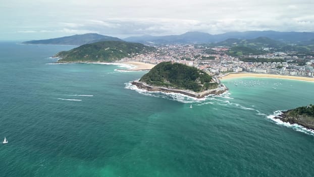 This breathtaking aerial shot beautifully showcases lush beaches and rocky islands along the stunning coast