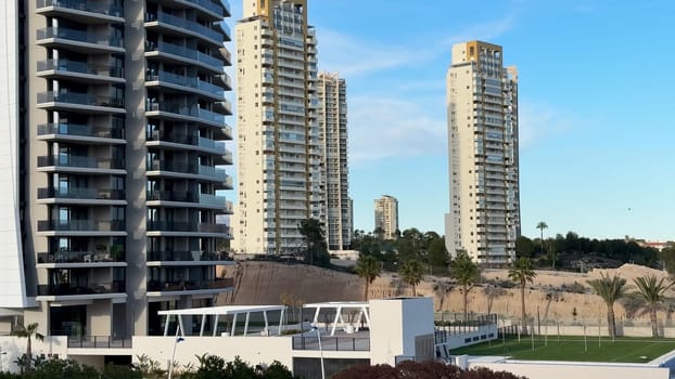 Immerse yourself in vibrant urban living, featuring stunning towers and lush green landscapes in this lively scene