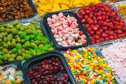assortment of dried fruits, sweets, candies and chewable marmalade on the Asian market in Asia