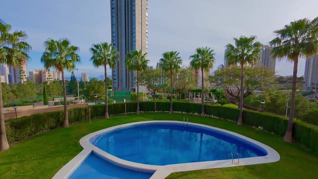A breathtaking pool view is gracefully framed by lush greenery and complemented by modern architectural designs