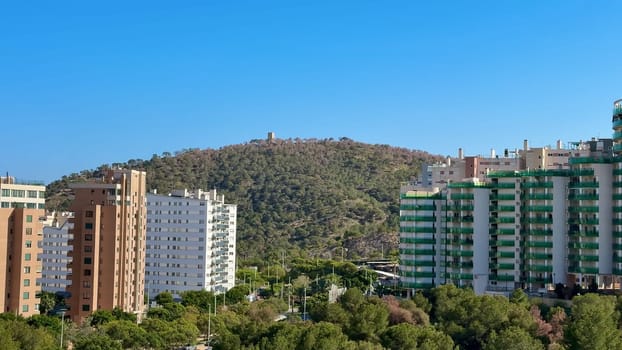 A breathtaking panorama of modern architecture among lush greenery, with a picturesque hillside backdrop