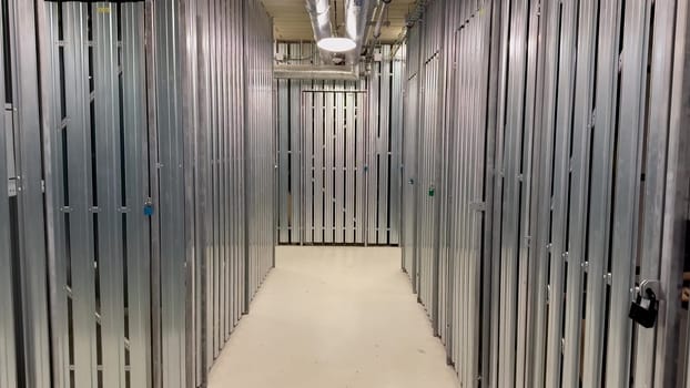 The interior view highlights a sleek and highly organized storage facility featuring numerous metal storage units