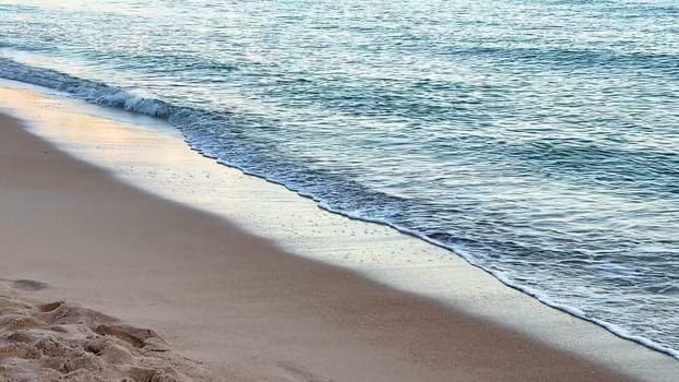 A serene and tranquil scene of gentle waves softly lapping at a beautiful sandy beach, perfect for ultimate relaxation