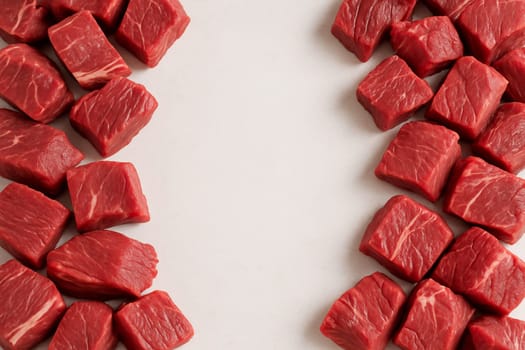 AI generated top view of fresh raw beef cut into pieces from various parts piled neatly vibrant red color on clean white background