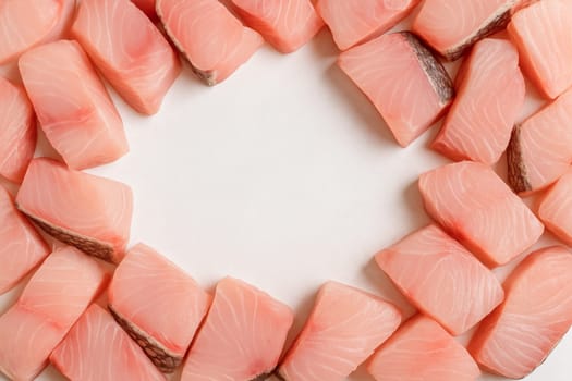 AI generated top view of fresh raw barramundi fish cut into premium fillets and chunks showcasing glistening texture and vibrant color on clean white space