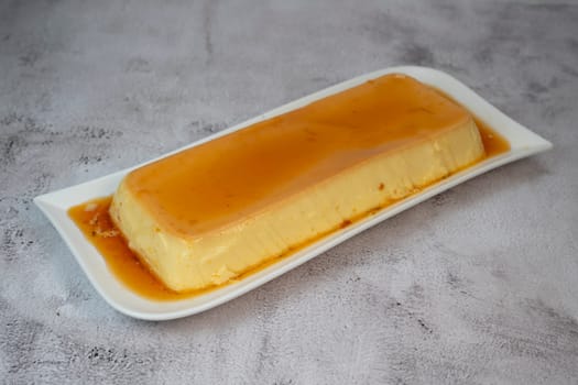 Cream caramel pudding with caramel sauce on a plate, Flan, High quality photo