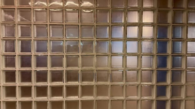 A closeup view of a textured glass block wall, skillfully creating a distinct and intriguing grid pattern