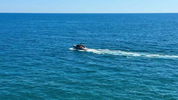 Immerse yourself in the exhilarating experience of jet skiing across the serene blue ocean waters on a sunny day